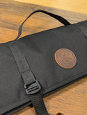 a leather patch on a black saw bag