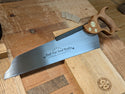a 14 inch half back saw with a cherry handle made by bad axe tool works